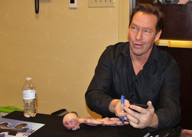 Checking his phone for quotes