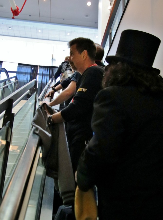 Television horror host, Svengoolie, ascends an escalator at a Chicago convention