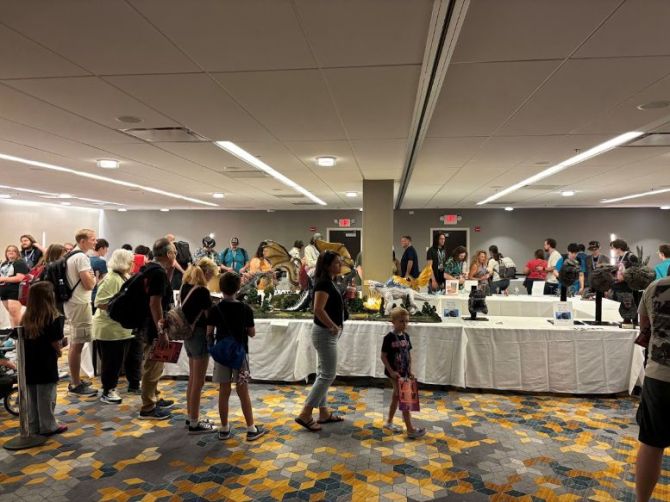 The image depicts guests at the 2026 Godzilla festival viewing models